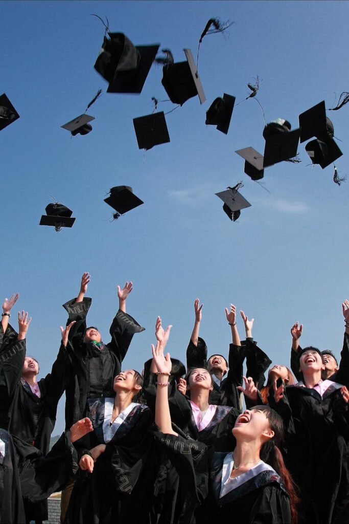 pexels-photo-267885-267885 Group of graduates celebrating by throwing caps in the air during a sunny day.